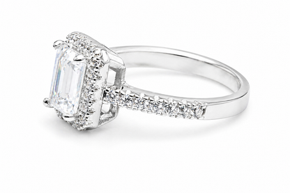 Side view of emerald cut moissanite ring with diamond halo band