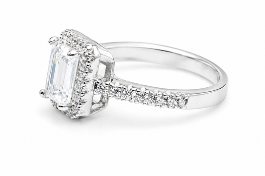 Side view of emerald cut moissanite ring with diamond halo band