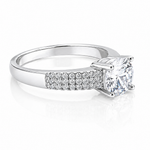 Close-up of a Round Moissanite Solitaire Ring with Accents 1.28CT | GRA Certified, featuring a sparkling round center stone and pavé-set accent stones on a polished band.