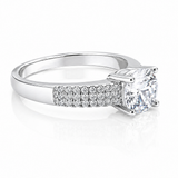 Close-up of a Round Moissanite Solitaire Ring with Accents 1.28CT | GRA Certified, featuring a sparkling round center stone and pavé-set accent stones on a polished band.