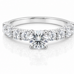 Round Moissanite Pave Engagement Ring 2.5CT | GRA Certified featuring a brilliant round center stone with a pave band of sparkling moissanite stones in a polished setting.