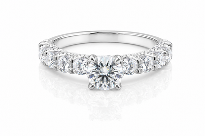Round Moissanite Pave Engagement Ring 2.5CT | GRA Certified featuring a brilliant round center stone with a pave band of sparkling moissanite stones in a polished setting.
