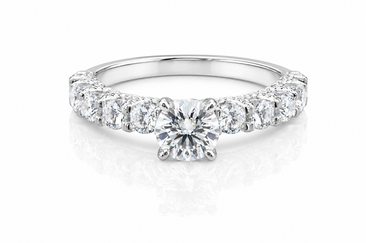 Round Moissanite Pave Engagement Ring 2.5CT | GRA Certified featuring a brilliant round center stone with a pave band of sparkling moissanite stones in a polished setting.