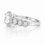 Oval Moissanite Halo Wedding Ring 2.3CT | GRA Certified featuring a sparkling oval center stone surrounded by a halo of smaller stones and additional round accents on a polished band.