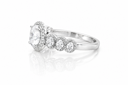 Oval Moissanite Halo Wedding Ring 2.3CT | GRA Certified featuring a sparkling oval center stone surrounded by a halo of smaller stones and additional round accents on a polished band.