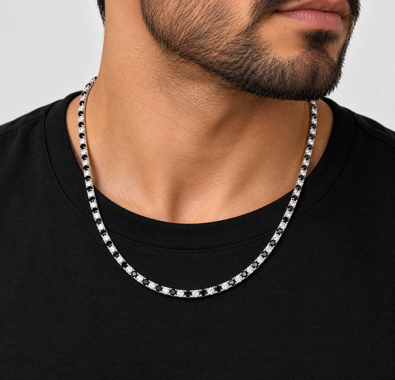 Black and white moissanite tennis chain worn on neck, alternating black and VVS D color stones