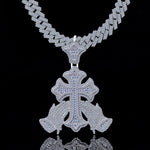 Silver necklace with a detailed cross pendant on a black background