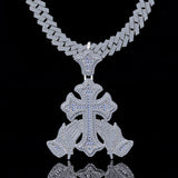 Silver necklace with a detailed cross pendant on a black background