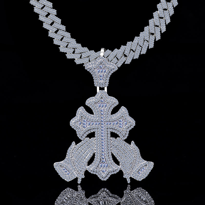 Silver necklace with a detailed cross pendant on a black background