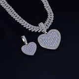 Silver heart-shaped pendant and necklace on a black background