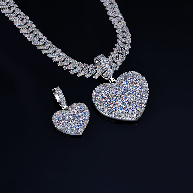 Silver heart-shaped pendant and necklace on a black background