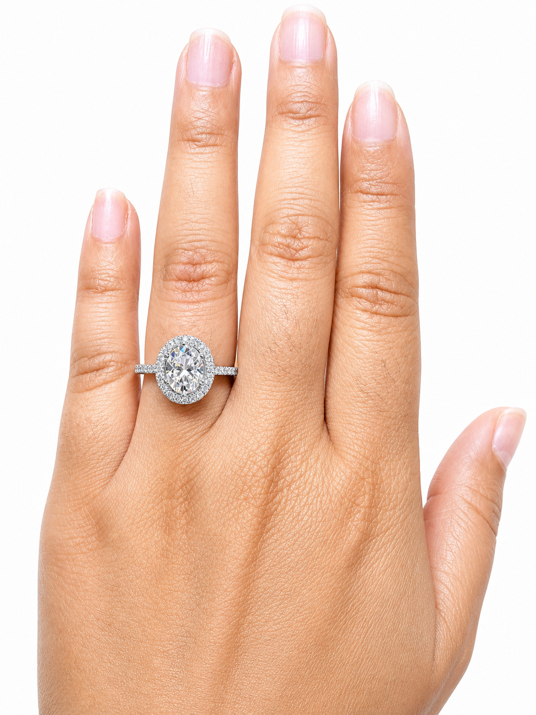 Hand displaying a 2.00 CTW DEW Oval Moissanite Halo Engagement Ring | GRA Certified 925 Silver on the ring finger, showcasing the oval-shaped stone surrounded by a halo of smaller stones on a silver band.