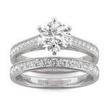 Close-up of a sparkling Moissanite Micro Pavé Bridal Ring Set 2.5CT | GRA Certified featuring a large round center stone with smaller pavé stones along the bands in polished metal.