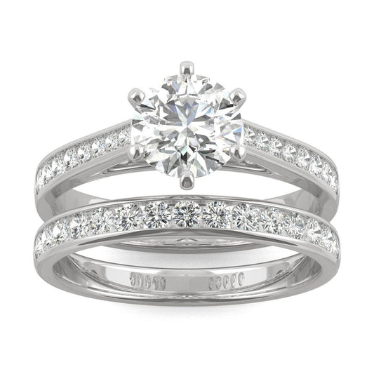 Close-up of a sparkling Moissanite Micro Pavé Bridal Ring Set 2.5CT | GRA Certified featuring a large round center stone with smaller pavé stones along the bands in polished metal.