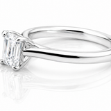 Classic Emerald Cut Moissanite Solitaire Ring 1CT | GRA Certified featuring a sleek, polished band with a sparkling emerald cut moissanite centerpiece.