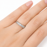 Close-up of a hand wearing the Moissanite Half Eternity Band – 1CT Round Cut VVS1 D Color | 925 Sterling Silver | GRA Certified Wedding Band for Women, sparkling with round cut stones.